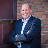 Stefan Freitag, Geschäftsführer der Energieservice Westfalen Weser Stefan Freitag, Geschäftsführer der Energieservice Westfalen Weser, steht vor dem Firmengebäude und lächelt in die Kamera.